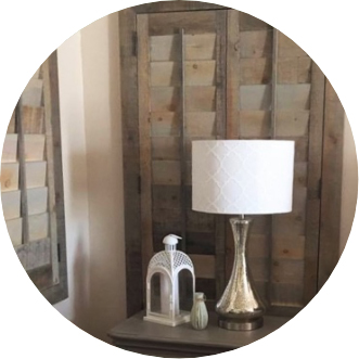 Reclaimed wood shutters in a living room corner with a lamp.