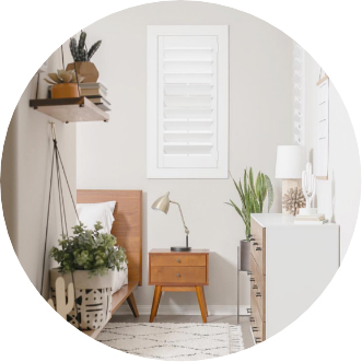 White polywood shutter window in a bedroom corner