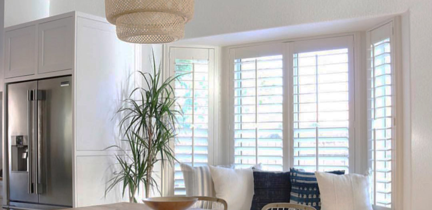 Bay windows with white polywood shutters