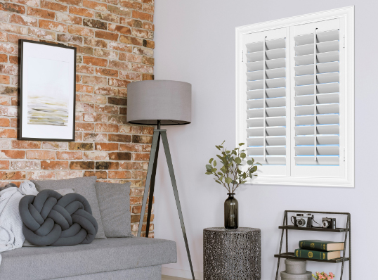 corner of living room with polywood shutters