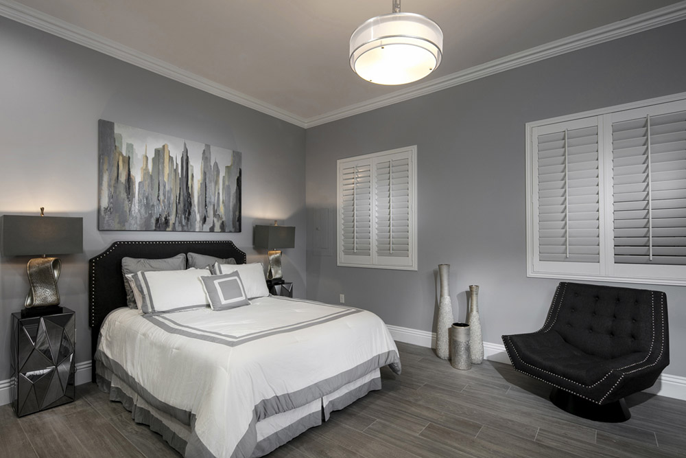 White polywood shutters in a dark gray bedroom